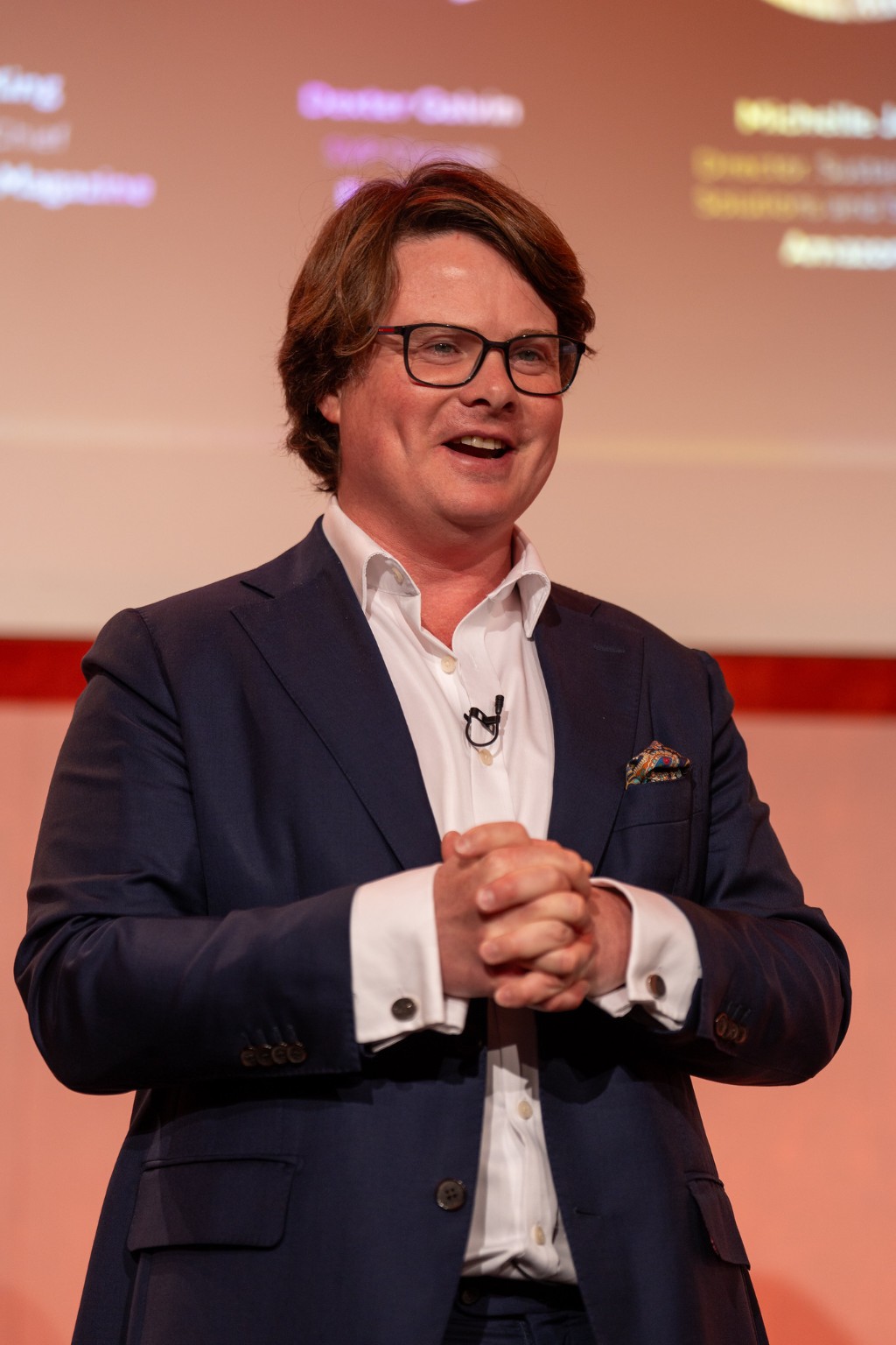Dexter Galvin speaking at Sustainability LIVE, smiling with his hands clasped